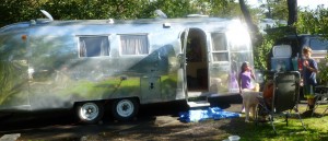A family enjoying the 1965 Airstream Overlander at the beach